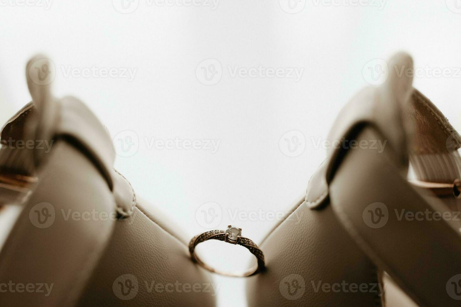 Close up of a gold ring with a diamond. Love, relationship and wedding concept. Soft and selective focus. Free space photo
