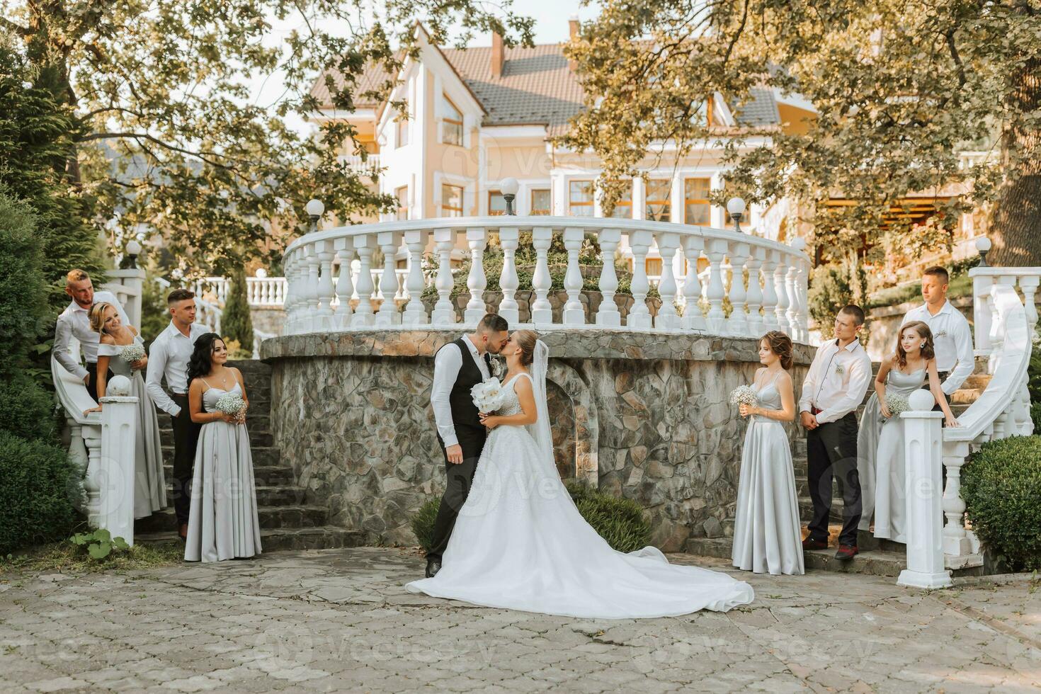 A beautiful couple at a wedding with friends in a beautiful location, staged photo