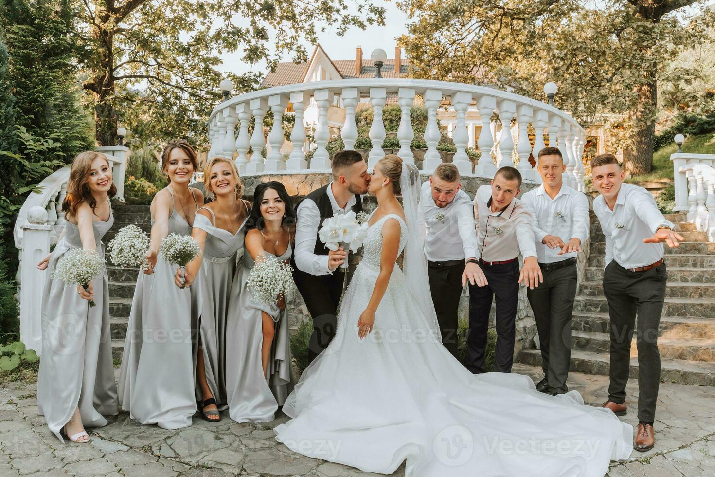 A beautiful couple at a wedding with friends in a beautiful location, staged photo