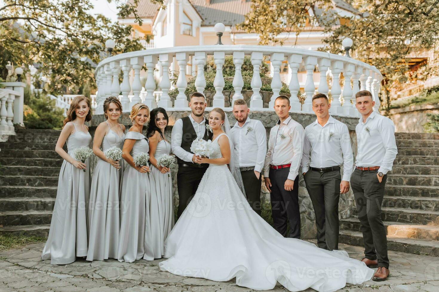 A beautiful couple at a wedding with friends in a beautiful location, staged photo