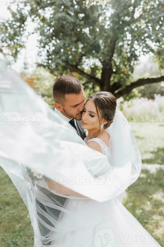 The bride and groom walk after the wedding ceremony. Young couple walking in the garden. photo in nature, forest, in nature.