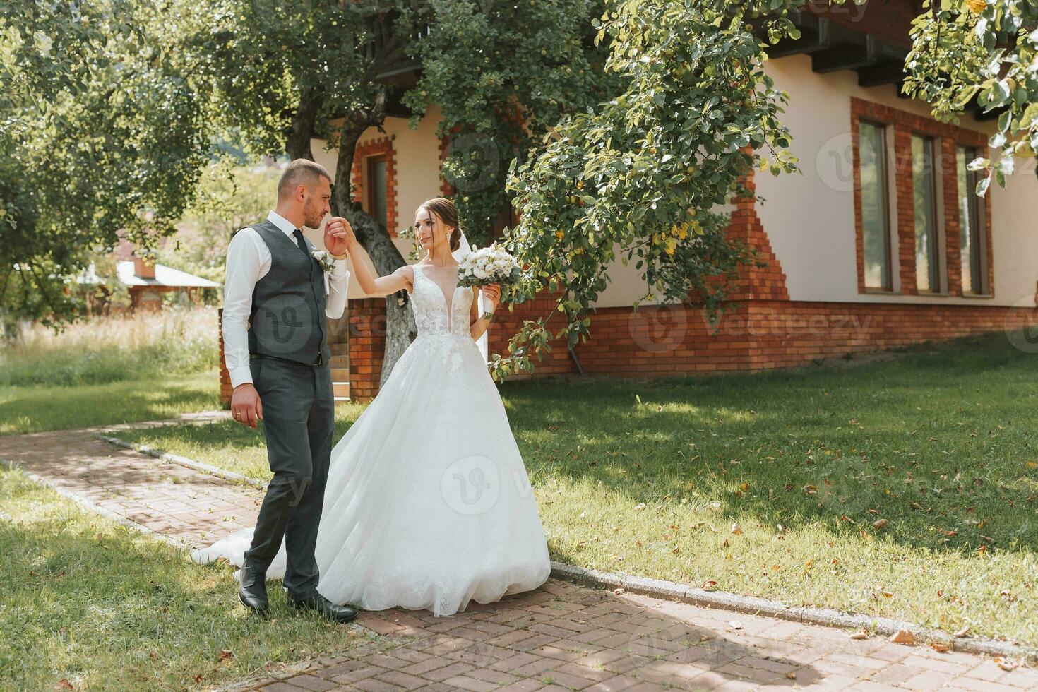 The bride and groom walk after the wedding ceremony. Young couple walking in the garden. photo in nature, forest, in nature.