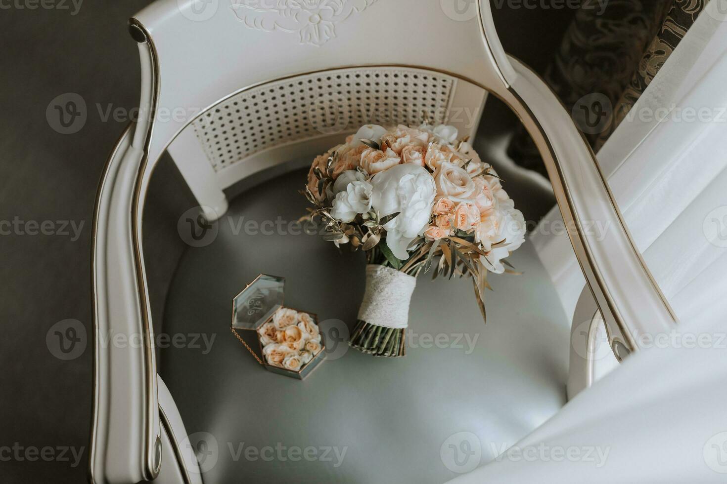 wedding bouquet of roses and various flowers on a chair in the wedding room photo