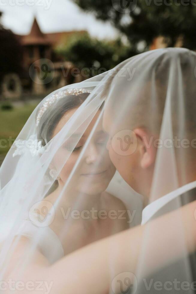 Couple, love or wedding dress veil after marriage event, ceremony or union in nature environment. Smile, happy or trust man or woman or bride and groom bonding after romance celebration by water lake photo