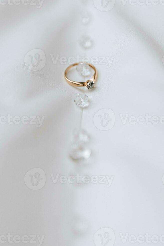 Golden women's ring with a precious stone on a white background photo