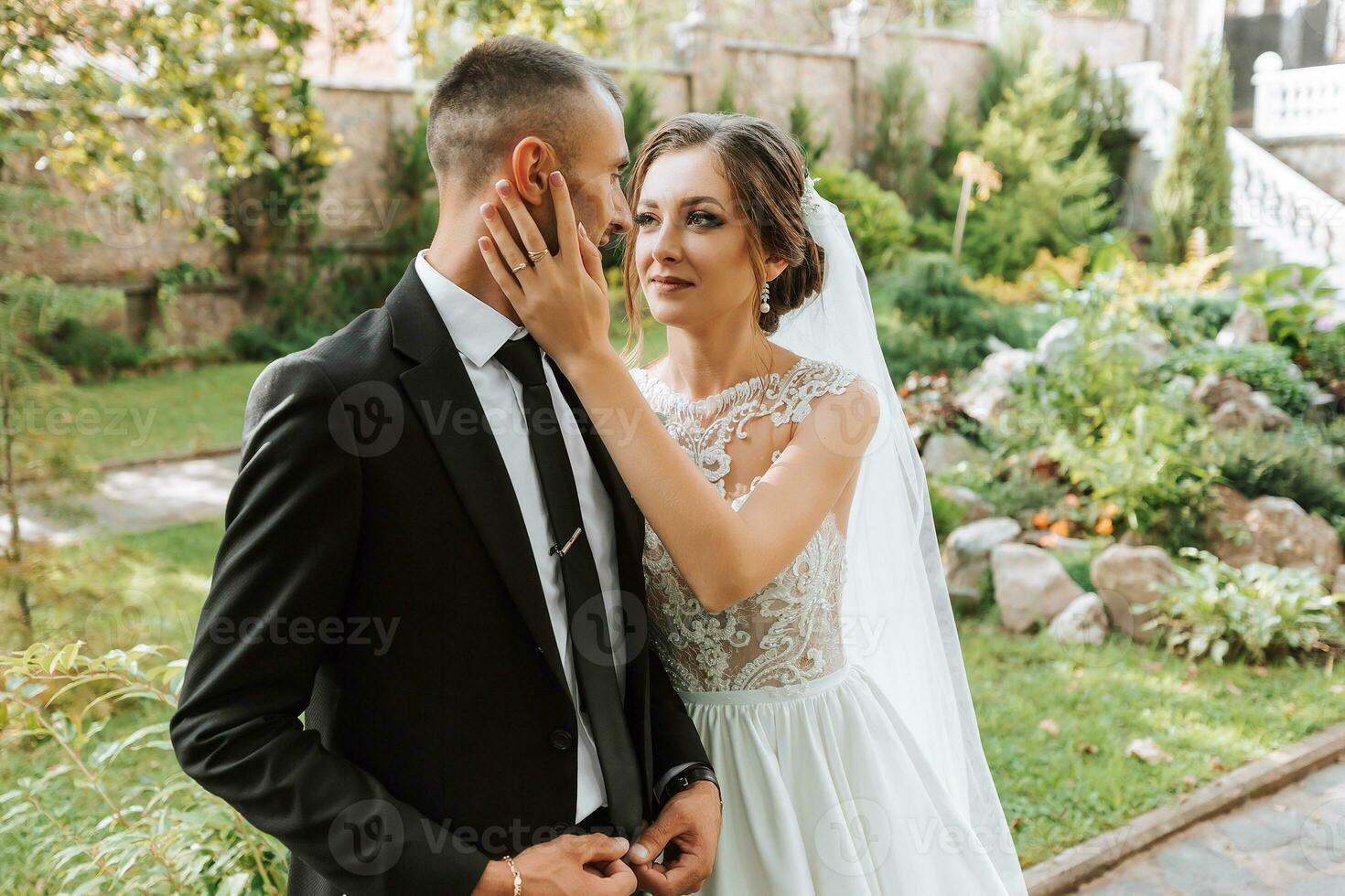 Young wedding couple enjoying romantic moments outdoors in autumn park under sunlight photo