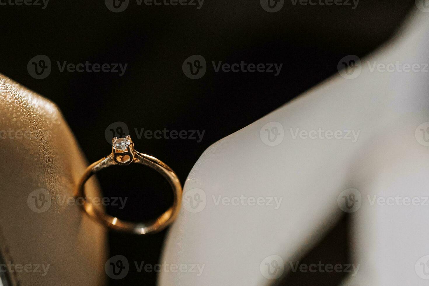 gold women's ring on a dark background, a man makes a marriage proposal to his girlfriend photo