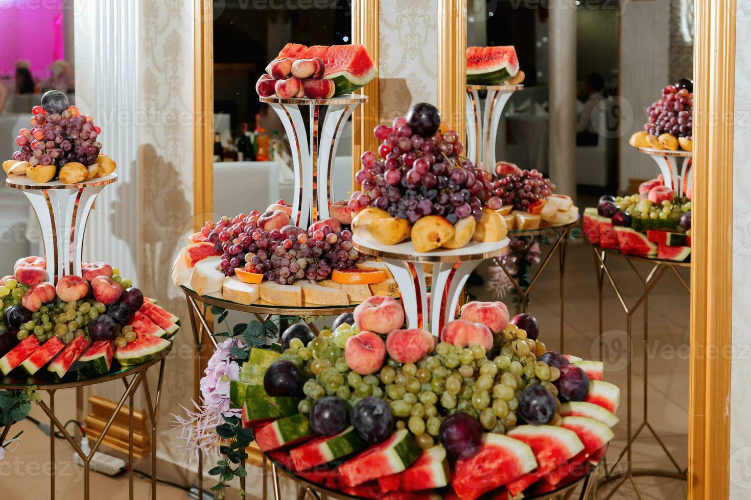 Wedding decorations. Reception. Buffet. Fruits and cheese on plates with bread in boxes. Food bar decorated by flowers and lanters photo