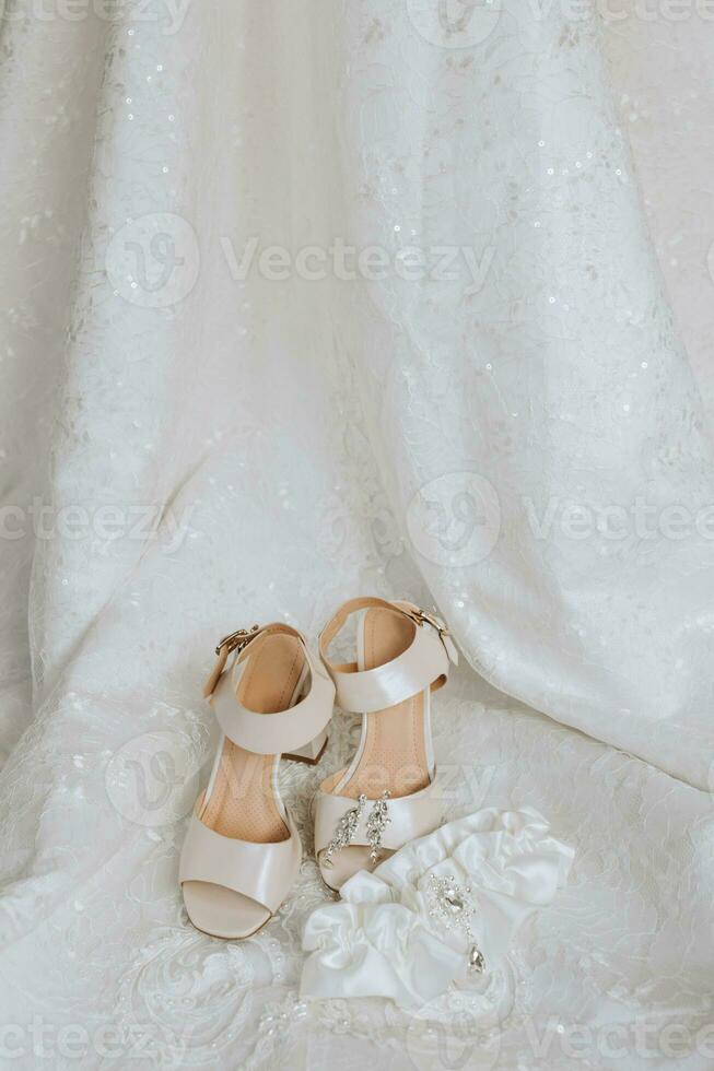 wedding concept. bride's shoes and veil. The bride's garter is white photo