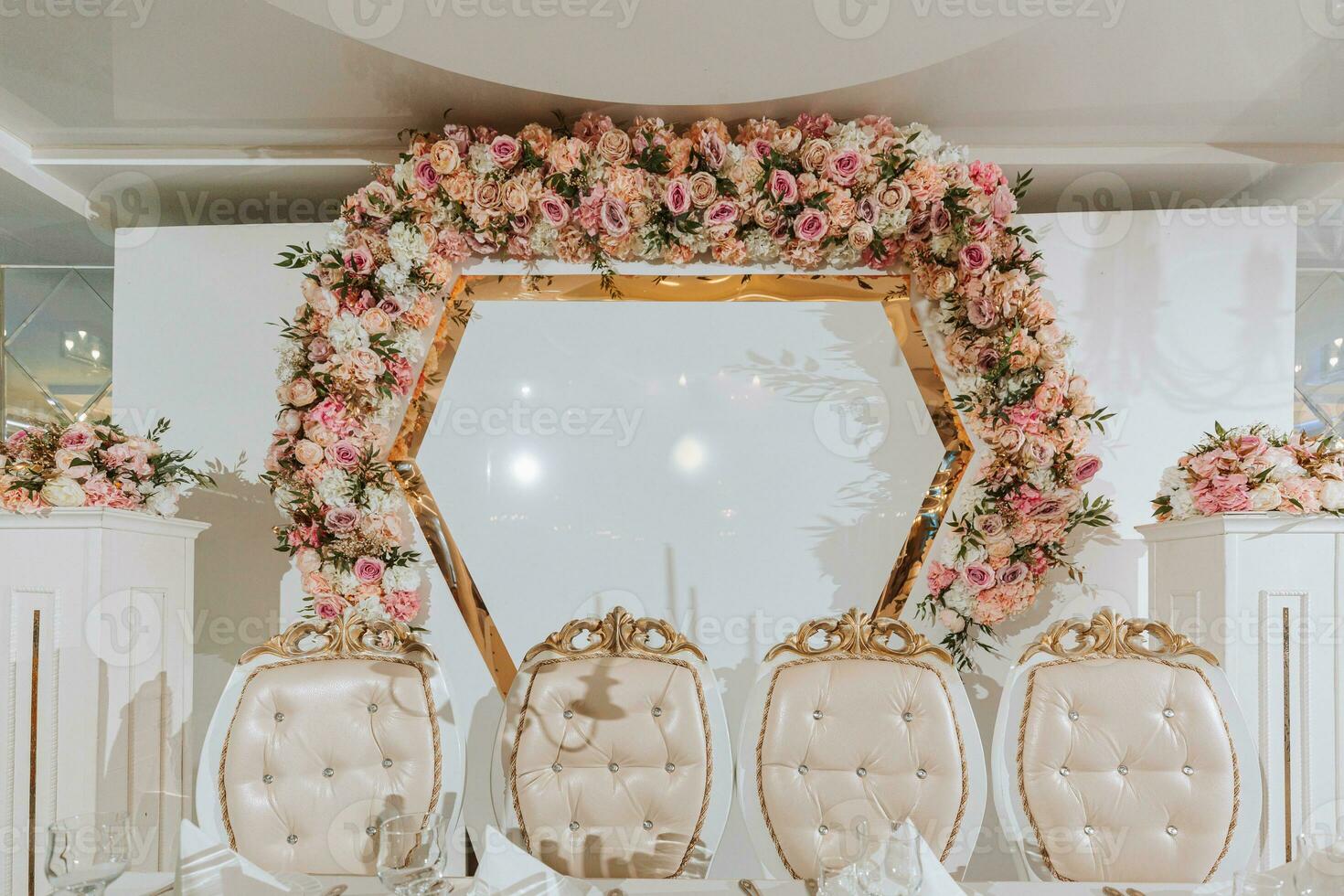 Presidium of the bride and groom at the wedding. Everything is almost ready for the wedding celebration. A wedding banquet, many flowers, a rich and refined wedding photo