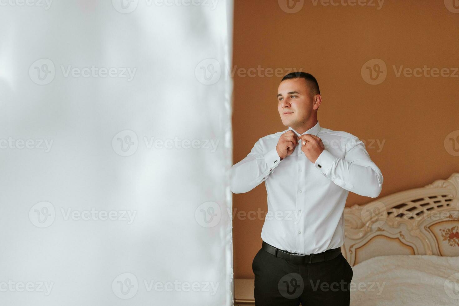 a man and a button-down shirt. clothing for interviews, work and corporate fashion for business. The hands of a male person, the groom is preparing for the wedding photo