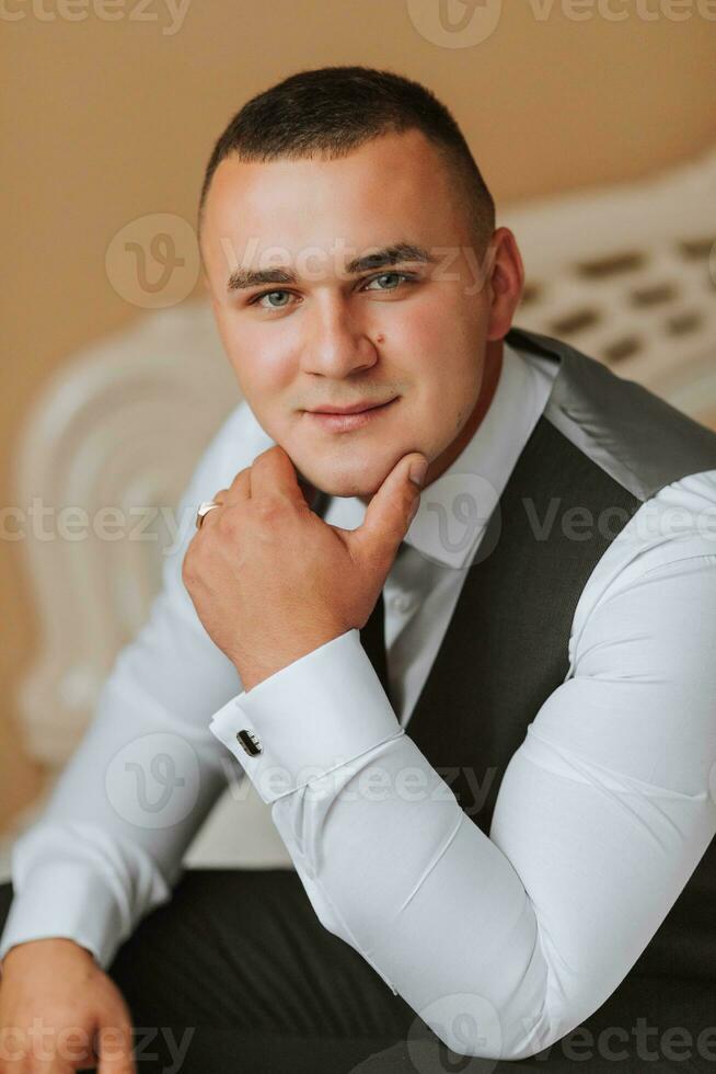 the man is wearing a shirt and vest. clothing for interviews, work and corporate fashion for business. The hands of a male person, the groom is preparing for the wedding. The groom is posing. Portrait photo