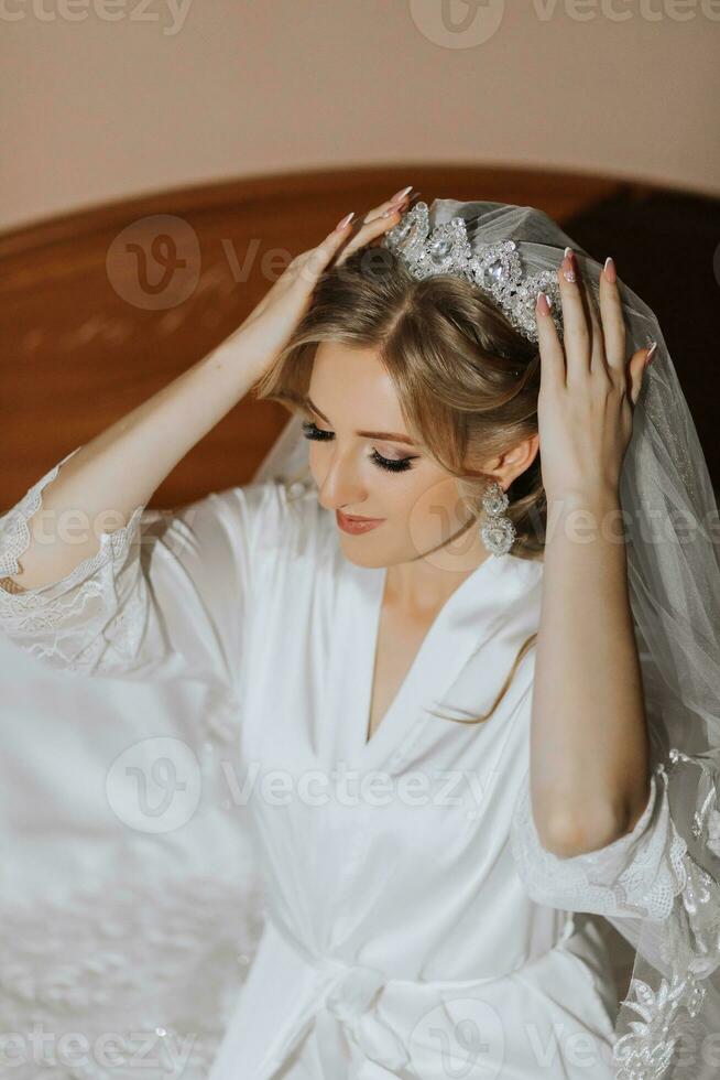 Luxury wedding crown diadem on bride's head hairstyle. morning wedding preparation bride with crown close up photo