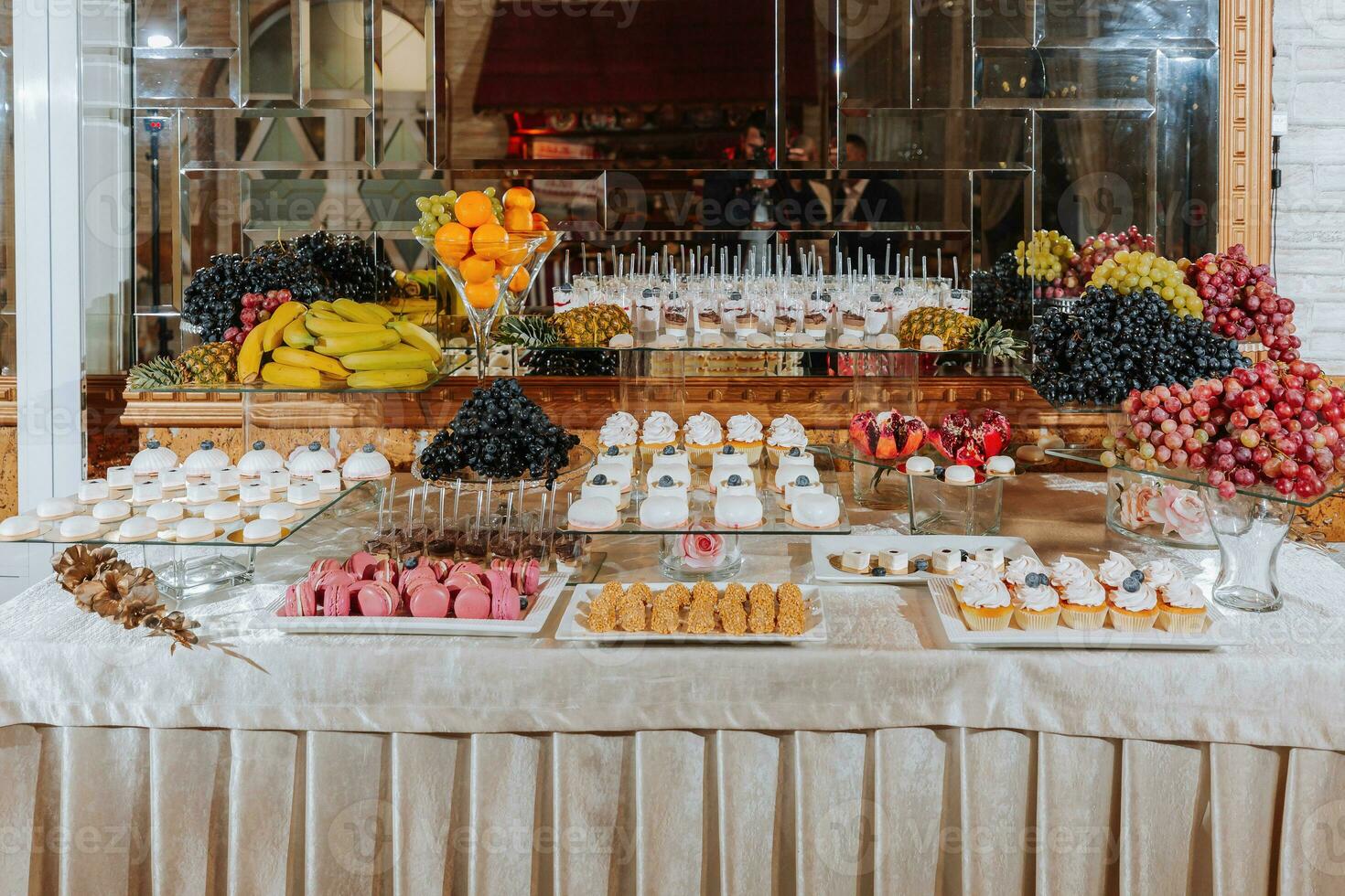 A delicious wedding. Candy bar with various chocolates. Fruit table. Celebration concept. Fashionable desserts. Table with sweets, candies. photo