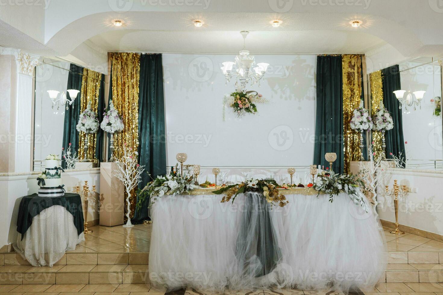 Presidium of the bride and groom at the wedding. Everything is almost ready for the wedding celebration. A wedding banquet, many flowers, a rich and refined wedding photo