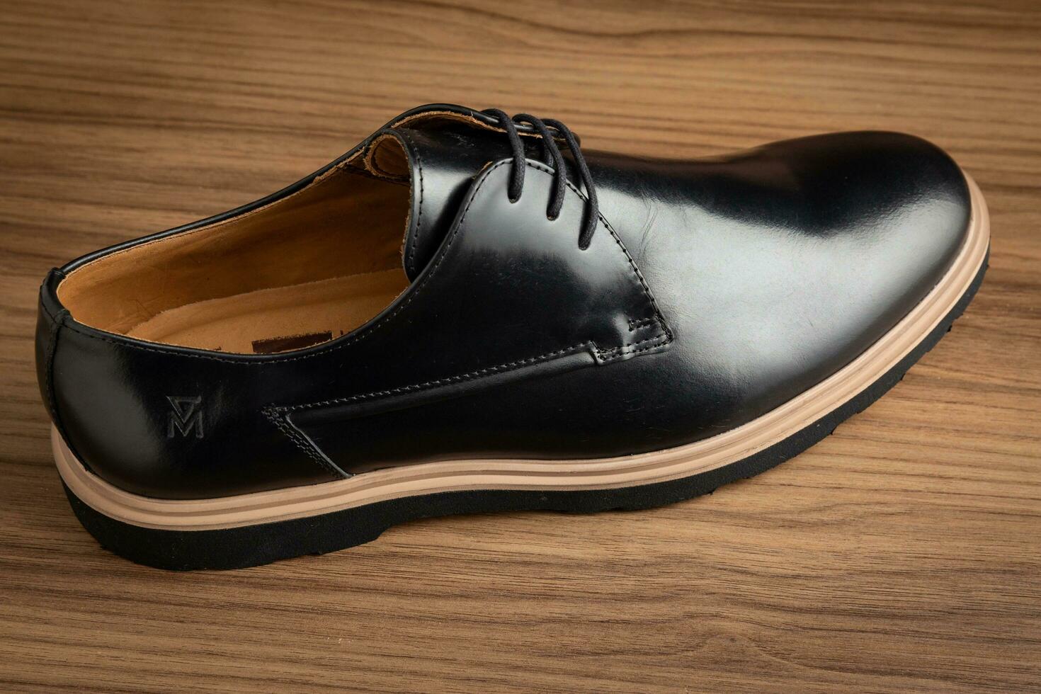 Men's black leather shoes on a wooden background. Selective focus. photo