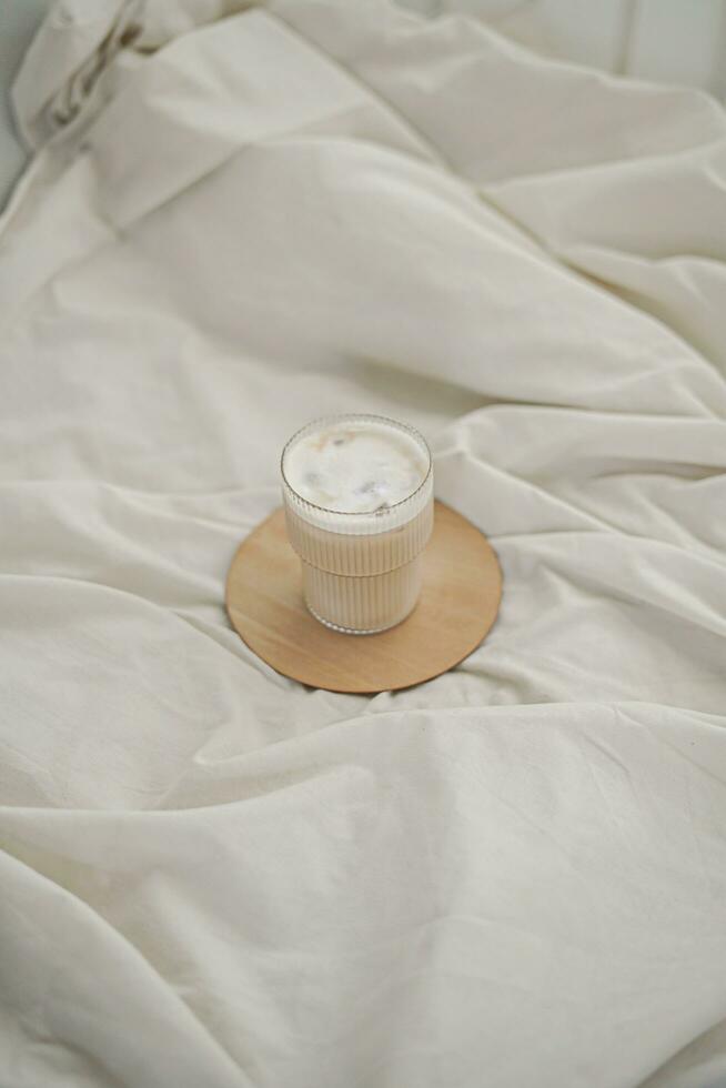 Coffee cup on the bed in the morning, stock photo