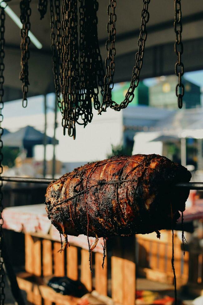 smoked meat on a street food stall. street food concept. photo