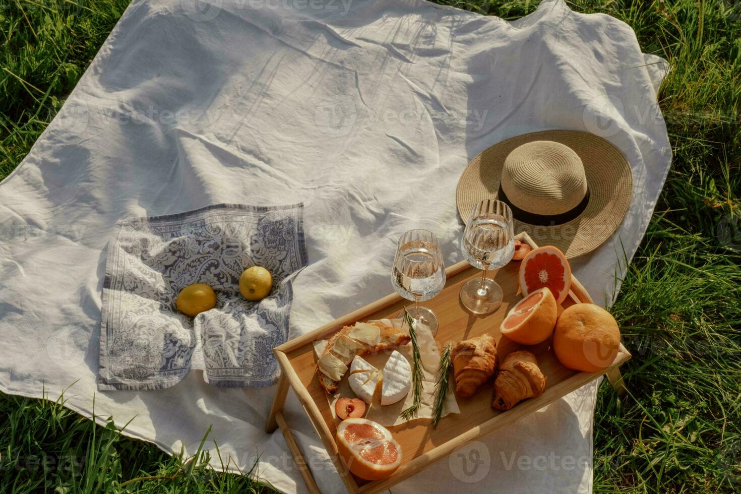 Picnic in the park. Top view of a wooden tray with food and drinks. photo