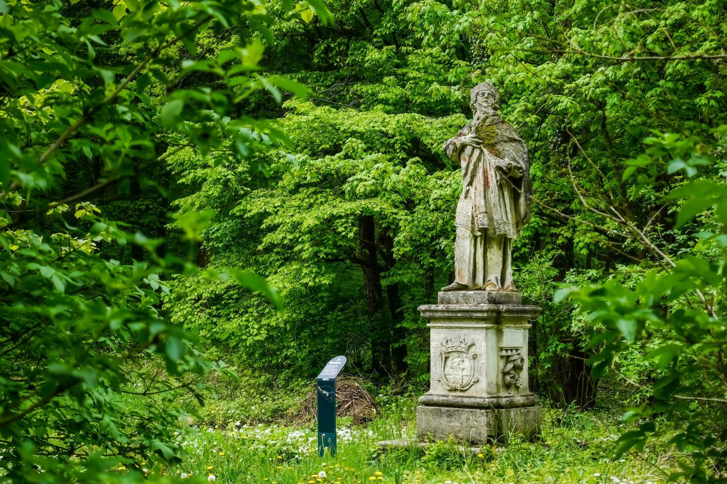 statue on a pedestal of a saint of a monastery photo