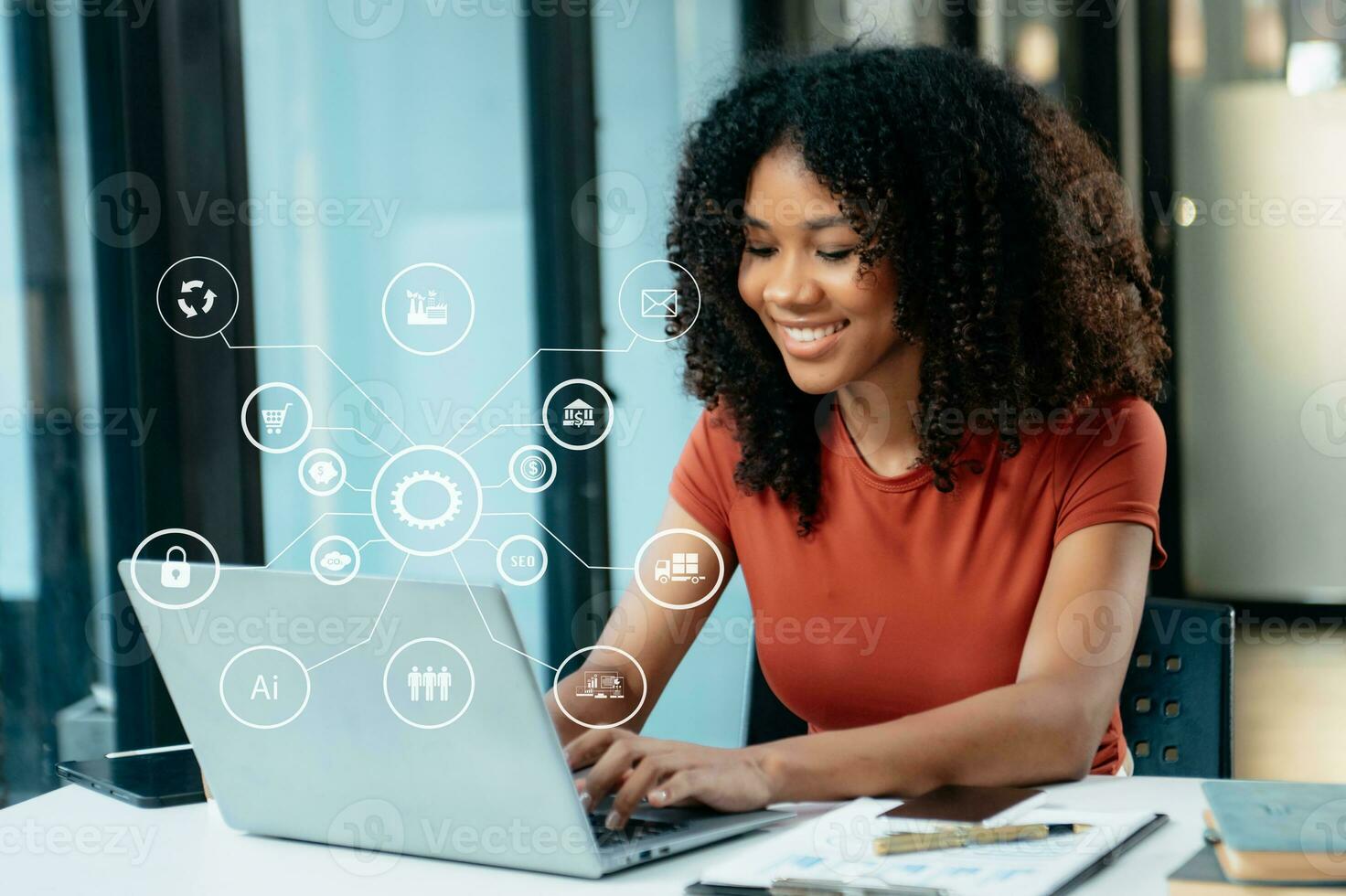 Designer African woman using smart phone for mobile payments online shopping sitting on table,virtual icons photo