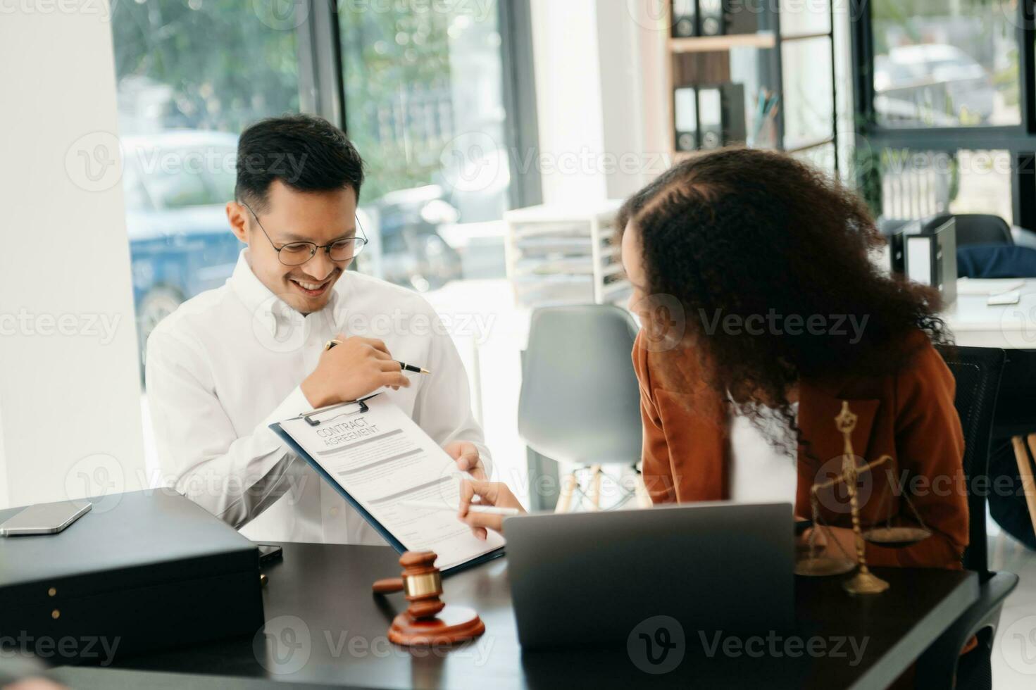 Asian business team and lawyers discussing contract papers sitting at the table. Concepts of law, advice, legal services. photo