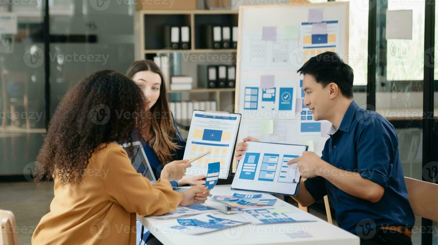 UX developer and ui designer brainstorming about mobile app interface wireframe design with customer breif and color code photo