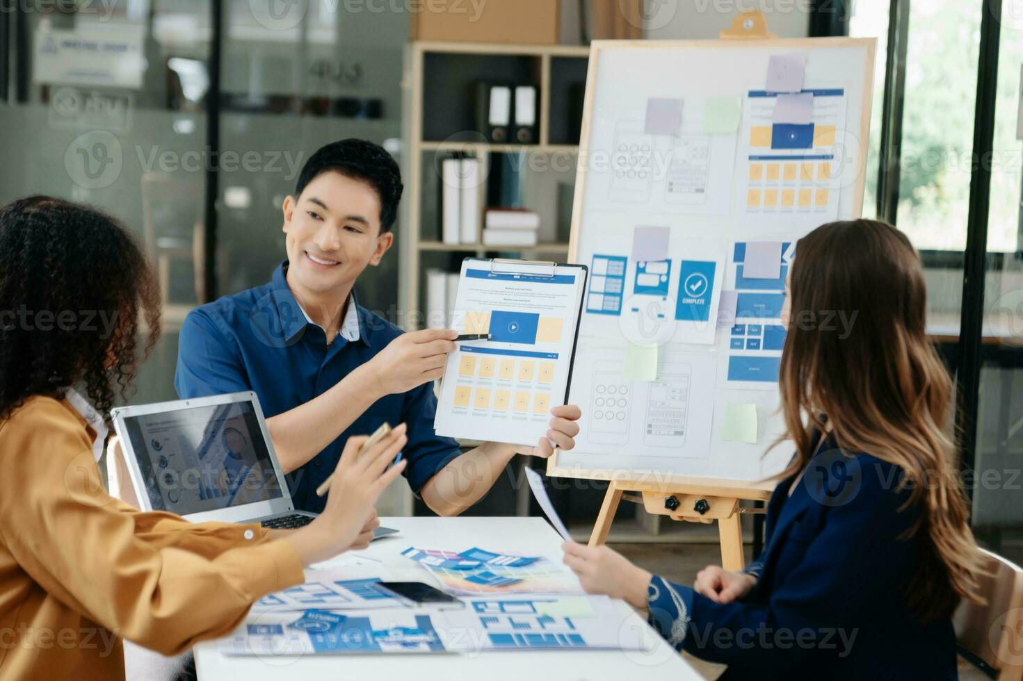 UX developer and ui designer brainstorming about mobile app interface wireframe design with customer breif and color code photo