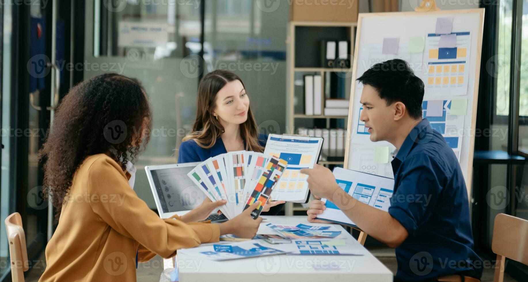UX developer and ui designer brainstorming about mobile app interface wireframe design with customer breif and color code photo