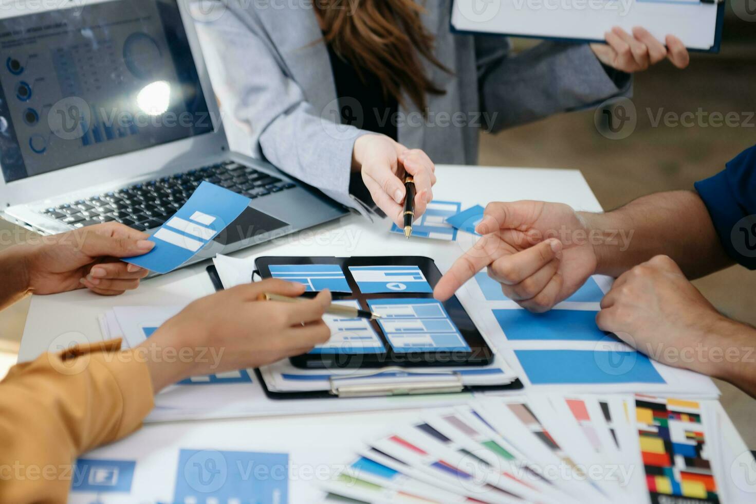 UI developer team brainstorming on their project with laptop, smartphone and digital tablet. Creative digital development agency. photo