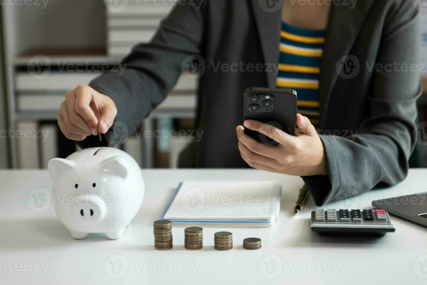 Business woman hand putting money coin into piggy bank with step of growing stack coins for saving money with virtual icon photo