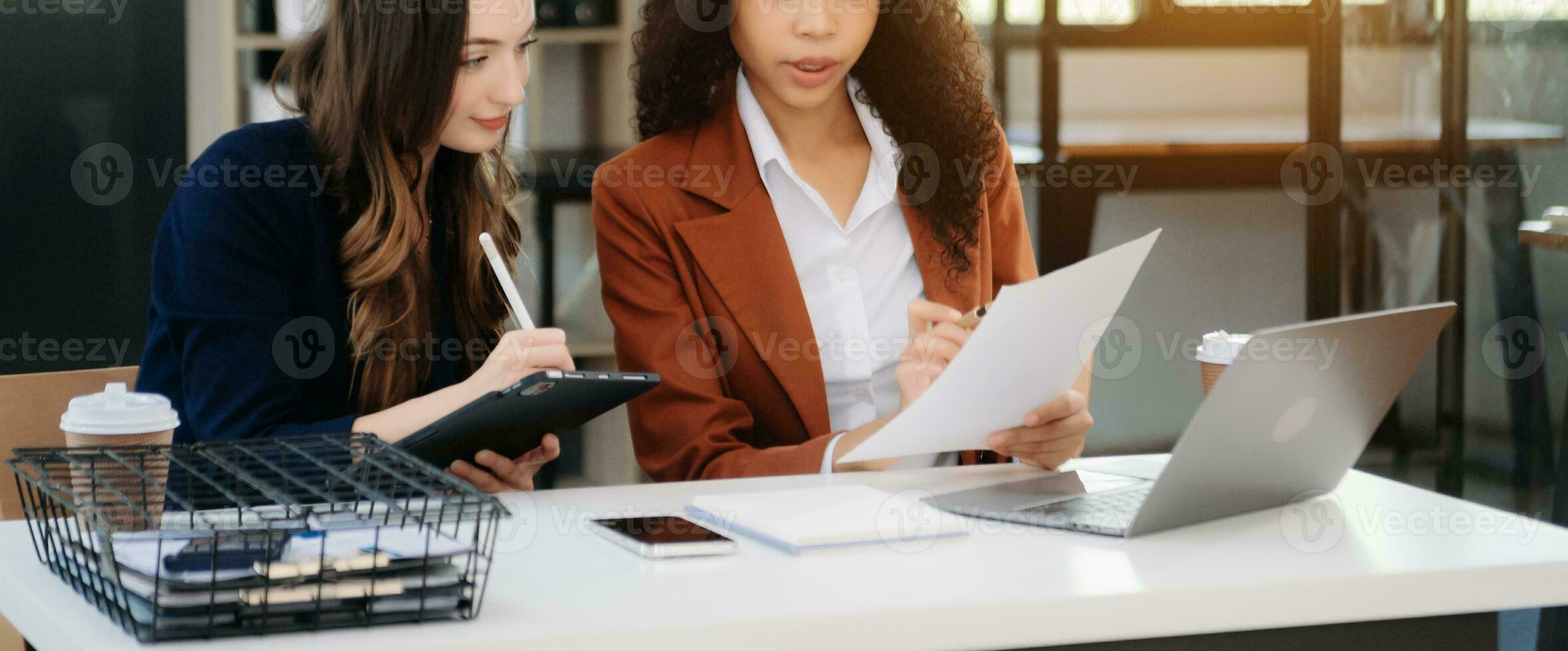 Business colleague business presents and explains and using laptop and tablet. Teamwork, financial marketing team, photo