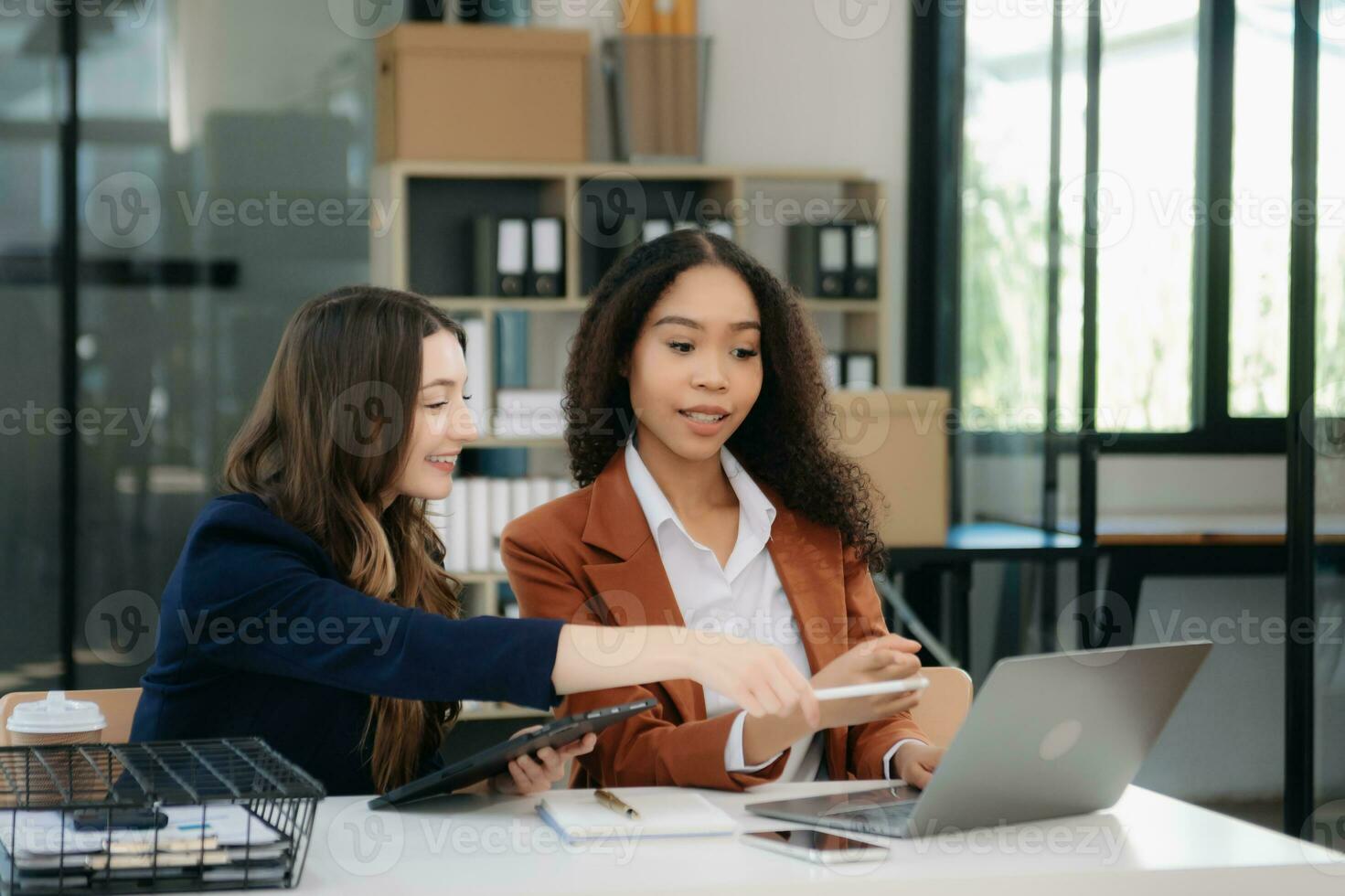 Business colleague business presents and explains and using laptop and tablet. Teamwork, financial marketing team, photo