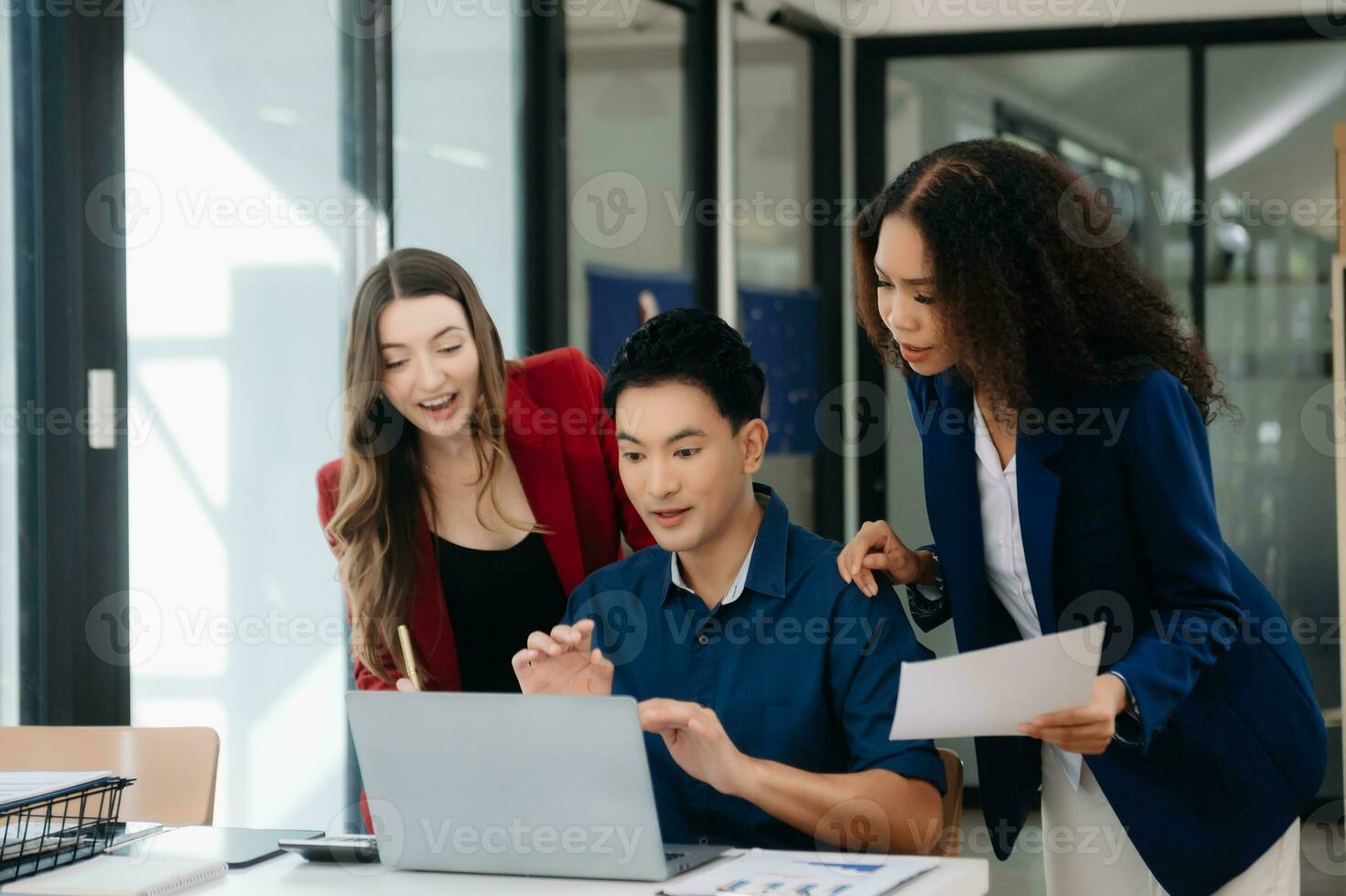 Office colleagues have a casual discussion. During a meeting in a conference room, a group of business teem sit in the conference room photo