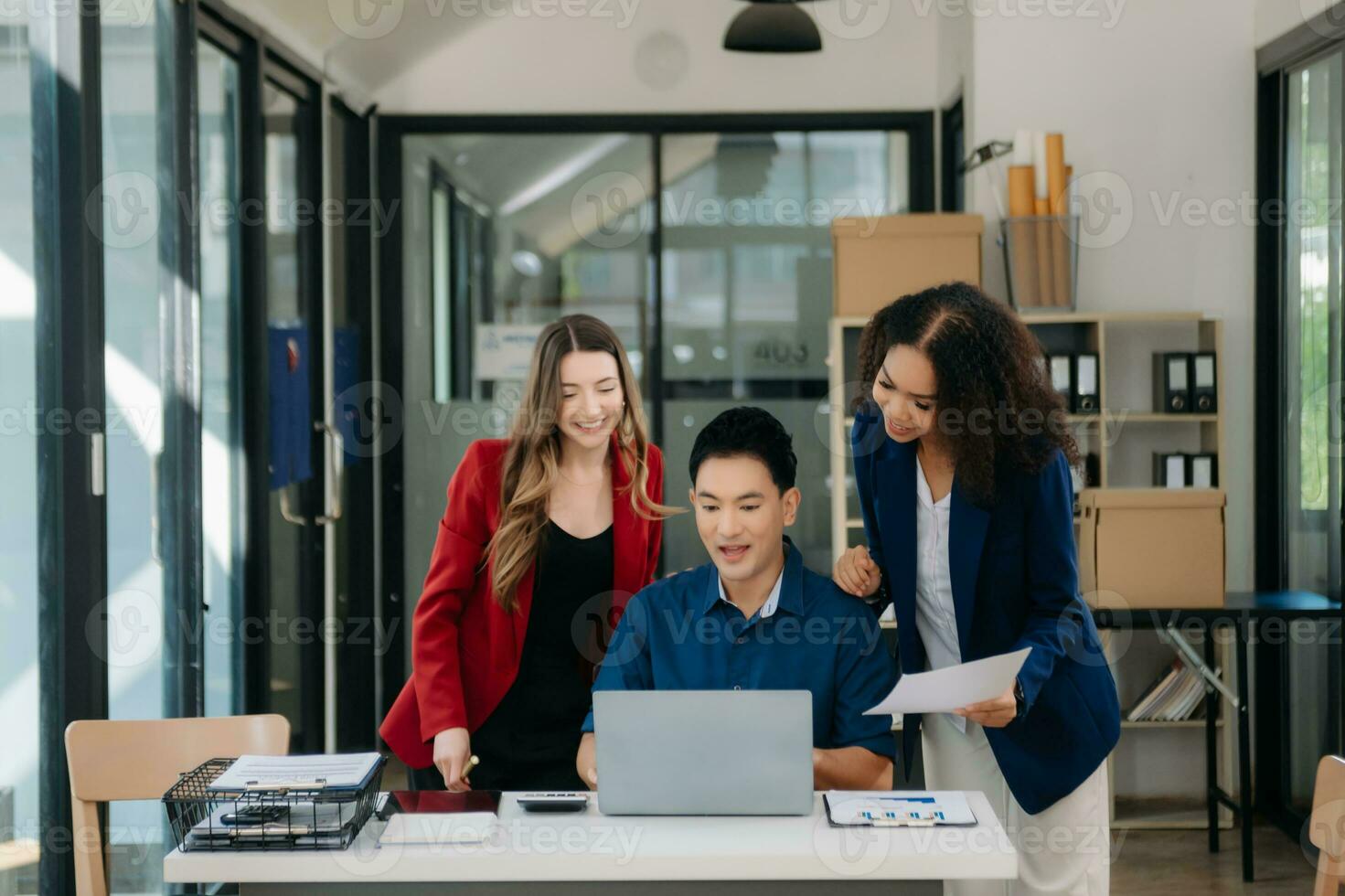 Office colleagues have a casual discussion. During a meeting in a conference room, a group of business teem sit in the conference room photo