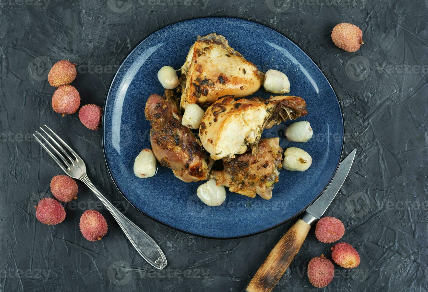 Roasted chicken pieces with lychee. photo