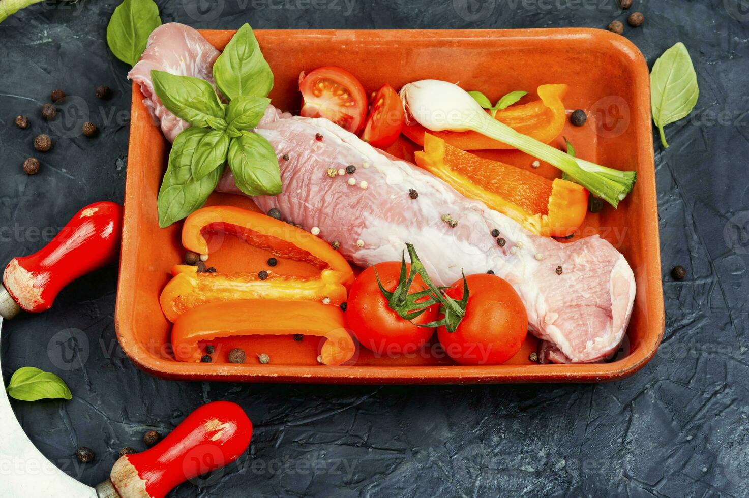 Raw uncooked meat tenderloin in a baking dish. photo