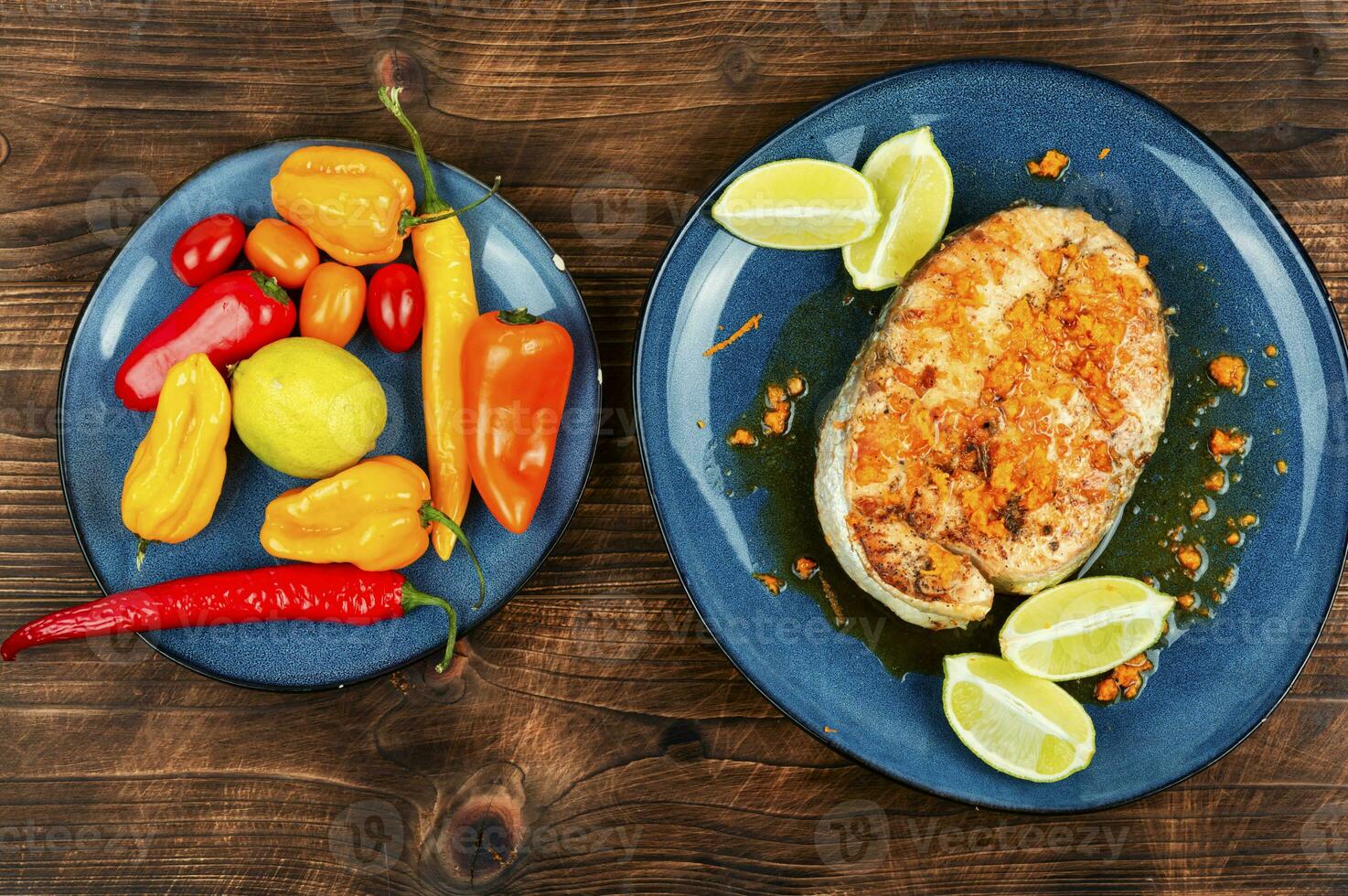 Fried salmon steak on wooden table photo