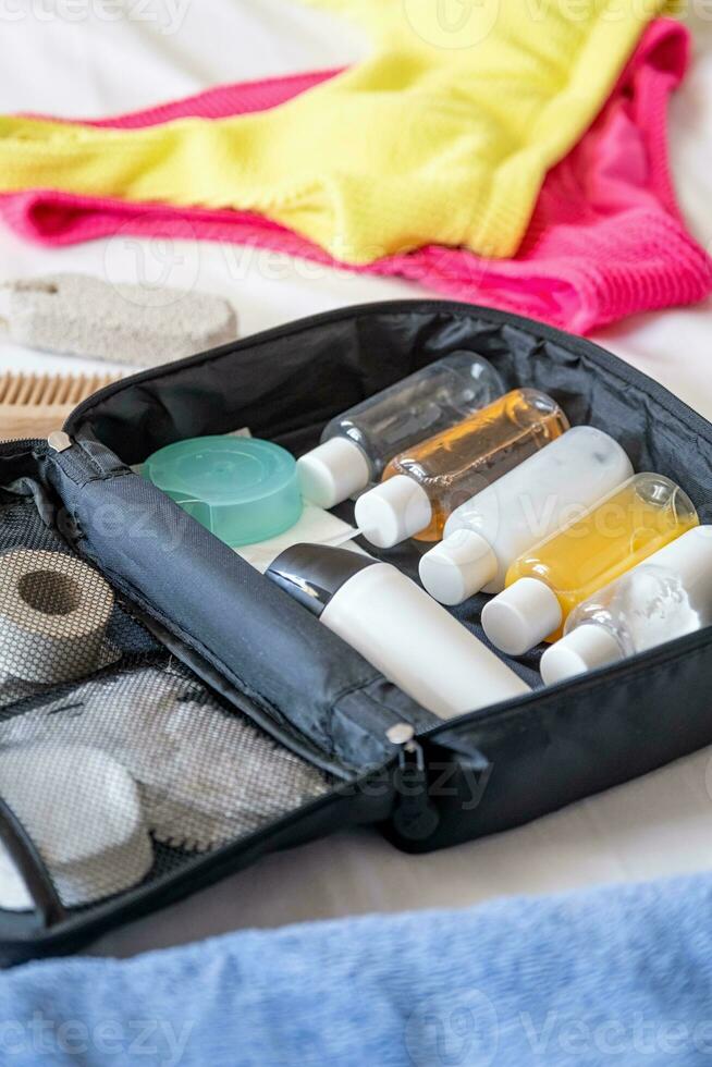 Travel cosmetics kit on bed photo