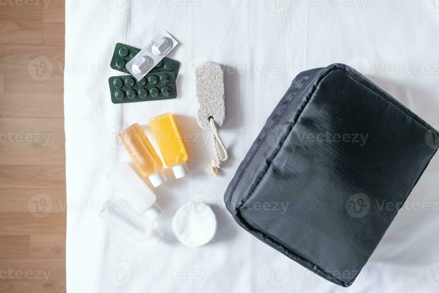 Travel cosmetics kit on bed , top view photo