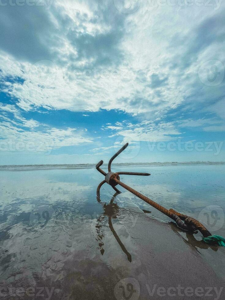 BEACH SEA-WAVE SAND AND WHITE SANDS OF A RUSSY ANCHOR photo