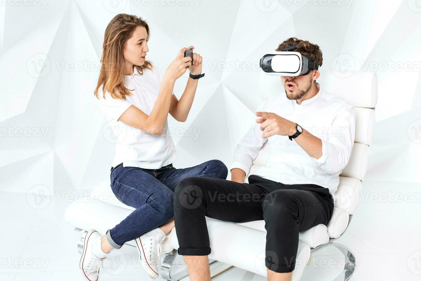 Couple having fun playing with virtual reality photo