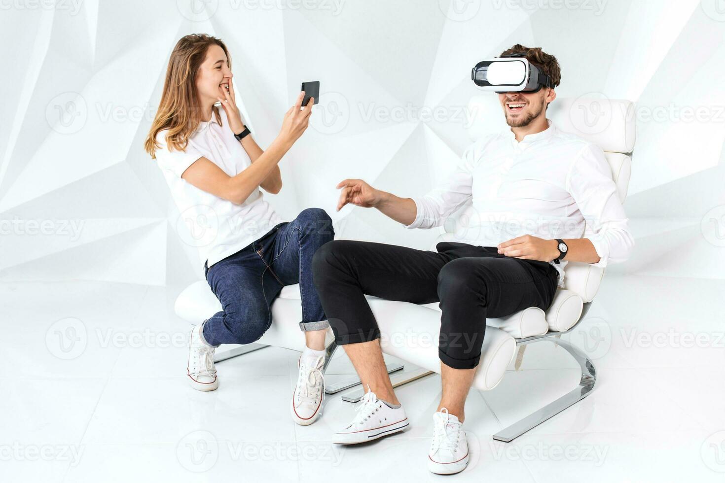 Couple having fun playing with virtual reality photo