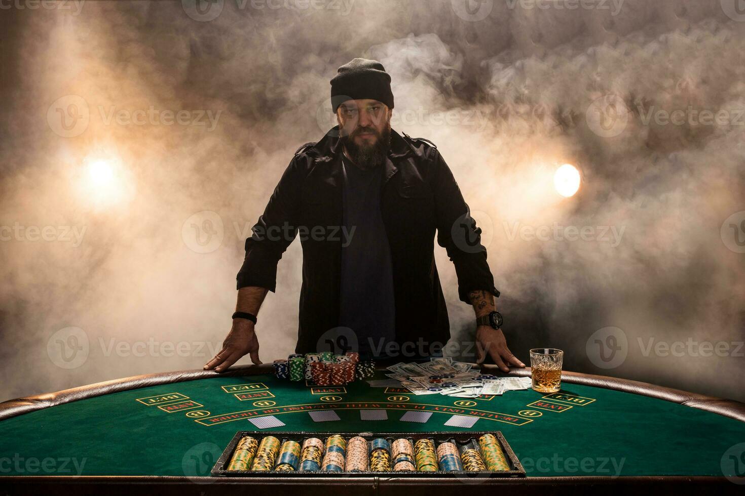 Male gambler playing poker, smoke dark color intensity. photo