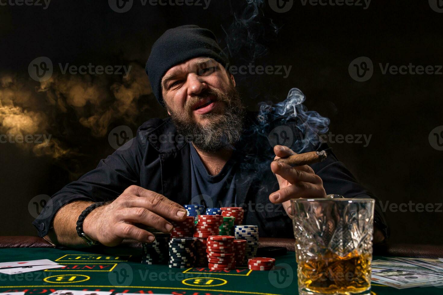 Man is playing poker. Emotional fail in game, game over for card player, man very angry with foolish choices, losing all the chips on bank. photo