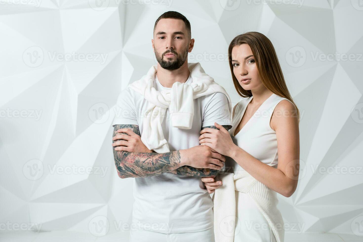 Fashionable couple posing at studio. photo