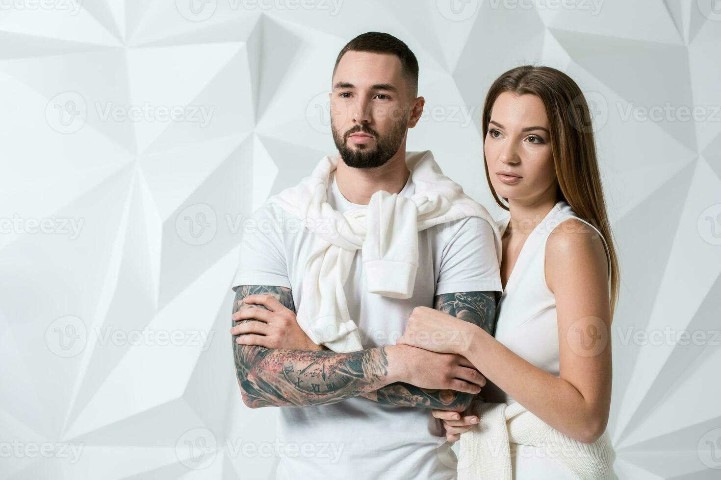 Fashionable couple posing at studio. photo
