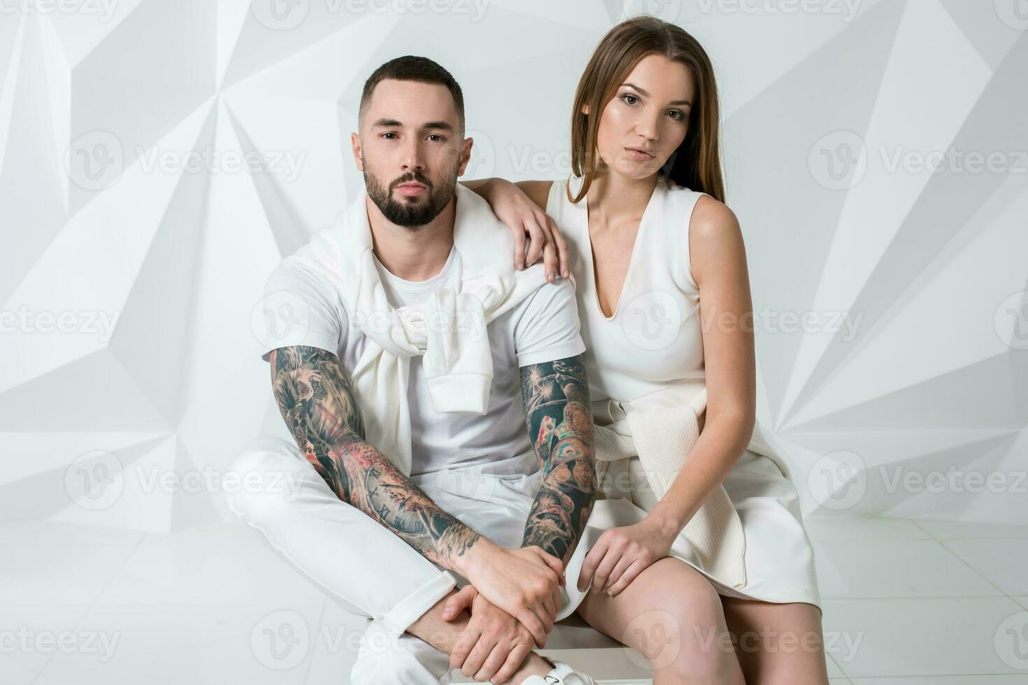 Fashionable couple posing at studio. photo