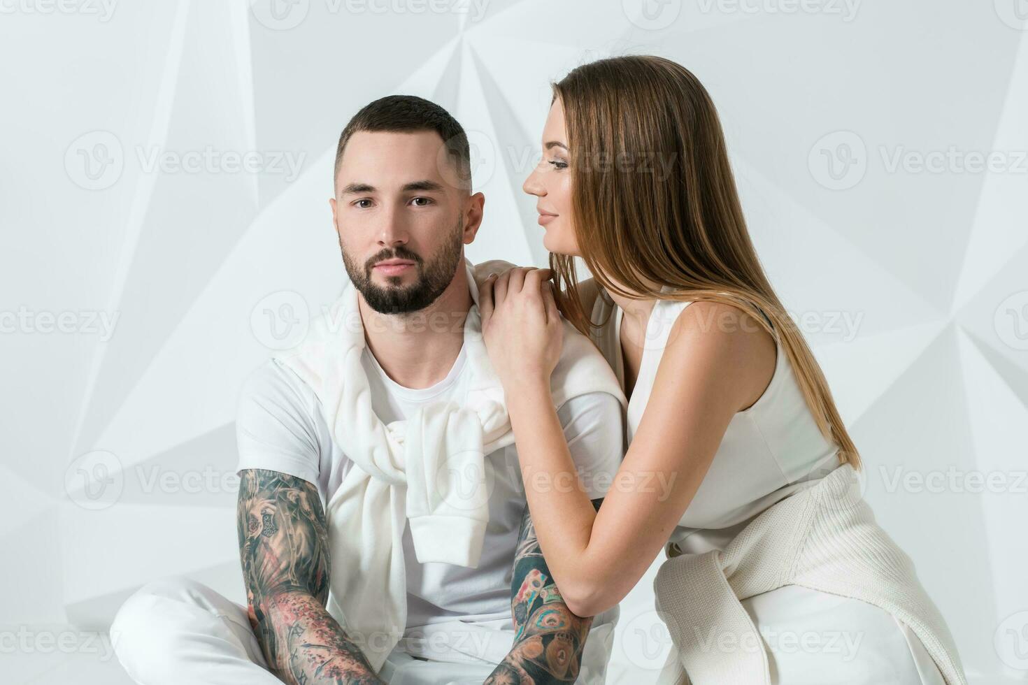 Fashionable couple posing at studio. photo