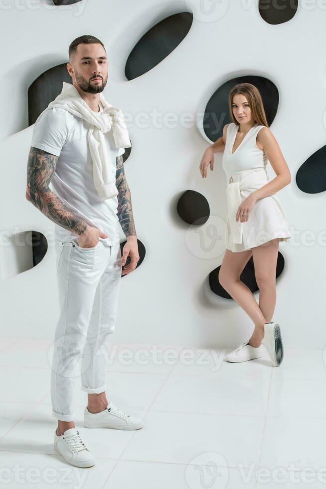 Young couple in casual clothing on white background photo